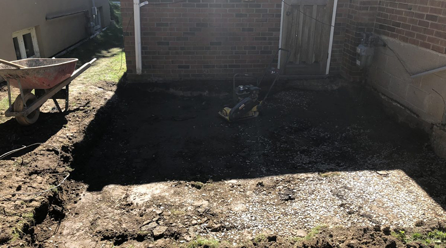 Excavated area at a Toronto home before installing a stone patio.
